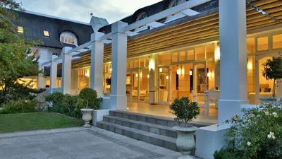 a building with a staircase in front of it at Le Franschhoek Hotel & Spa by Dream Resorts in Franschhoek