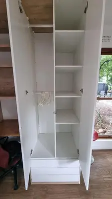 a white cabinet with glass doors in a room at Stellebosch garden flat in Stellenbosch