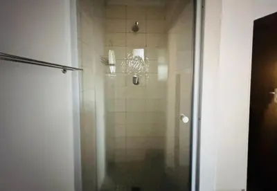 a shower with a glass door in a bathroom at Stellebosch garden flat in Stellenbosch