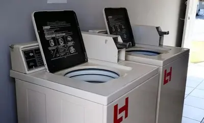 two white washing machines are sitting next to each other at 46 Atlanta - A Home away from Home in Strand