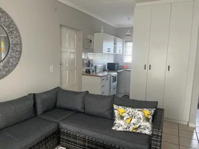 a living room with a couch and a kitchen at 46 Atlanta - A Home away from Home in Strand