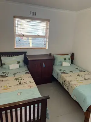 a bedroom with two beds and a window at 2 Elwyn Road