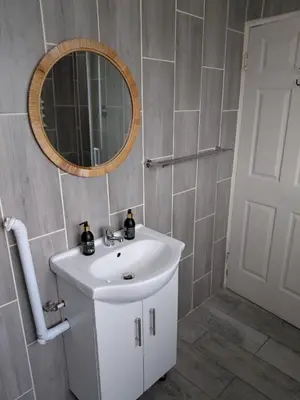a bathroom with a white sink and a mirror at Unit 8 Hermanus Beach Club in Hermanus