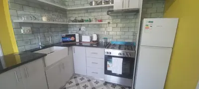 a kitchen with a white refrigerator and a stove at Unit 8 Hermanus Beach Club in Hermanus