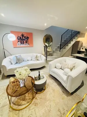 a living room with two white couches and a staircase at Tranquil Luxe Retreat in Cape Town
