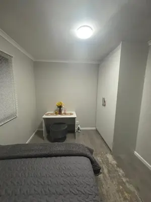 a bedroom with a bed and a table in it at Tranquil Luxe Retreat in Cape Town