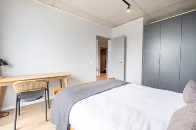 a bedroom with a white bed and a desk at 723 Riverlands - Lux 1 bedroom Apartment in Cape Town