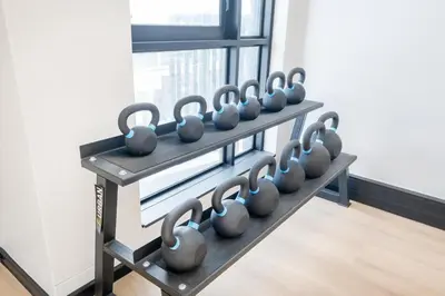 a row of dumbbells on a rack in a gym at 723 Riverlands - Lux 1 bedroom Apartment in Cape Town
