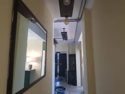 a hallway leading to a room with a mirror at 4th On Boundary in Gordonʼs Bay
