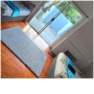 a living room with a couch and a window at Ridah's Accomodation in Bellville