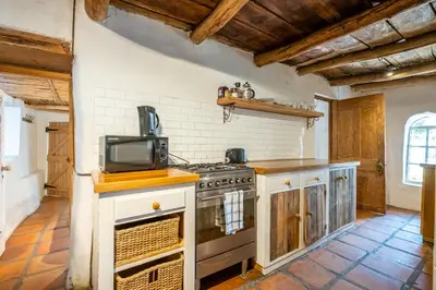 a kitchen with a stove and a microwave at Natte Valleij in Klapmuts