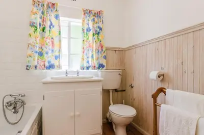 a bathroom with a toilet and a sink and a tub at Natte Valleij in Klapmuts