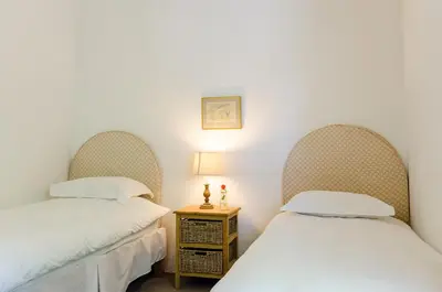 two beds sitting next to each other in a room at Natte Valleij in Klapmuts