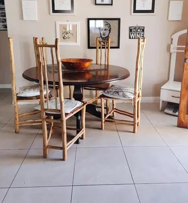 a dining room with a wooden table and chairs at The Palm's on Pastorie in Pniel