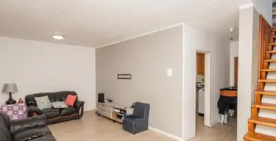 a living room with a couch and a table at p22 voevlei in Victory Hill