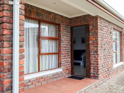 a brick house with a door and windows at Gulls Nest in Hermanus