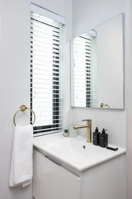 a white bathroom with a sink and a mirror at CAG The Alxndr Stellenbosch in Stellenbosch