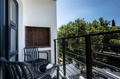 two chairs on a balcony with a view at CAG The Alxndr Stellenbosch in Stellenbosch