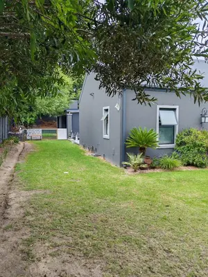 a gray house with a yard in front of it at Franschhoek Guest Suite in Franschhoek