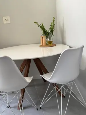 a white table and two white chairs in a room at De Eike in Stellenbosch
