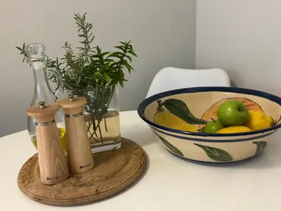 a bowl of fruit next to a bowl of fruit at De Eike in Stellenbosch