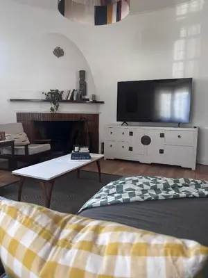 a living room with a flat screen tv and a couch at Catlovers Corner in Paarl