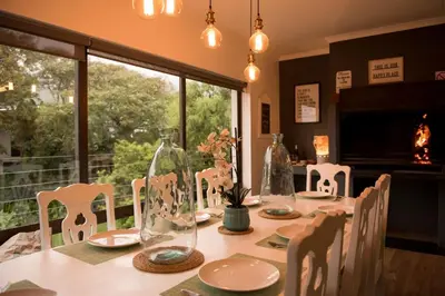 a table with chairs and vases on top of it at CalTye On Sea in Hermanus