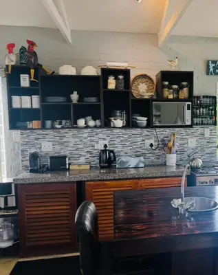 a kitchen with a sink and a counter top at Fynbos Mountain View in Kleinmond