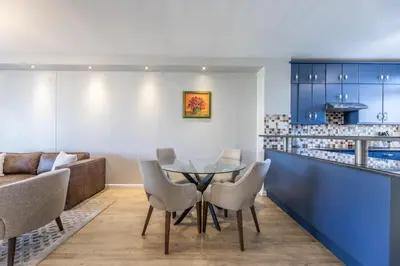 a dining room with a table and chairs at Portifino on lake 221 The Island Club in Cape Town