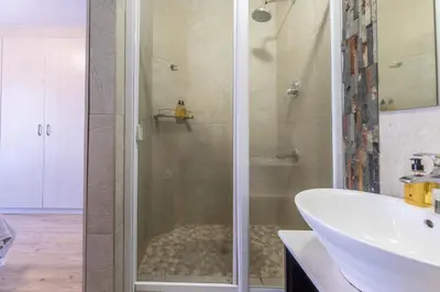 a bathroom with a shower and a sink at Portifino on lake 221 The Island Club in Cape Town