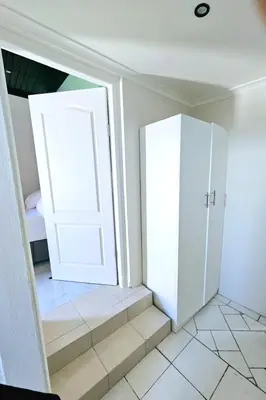 a room with a white door and stairs at Evernice Guest House in Cape Town