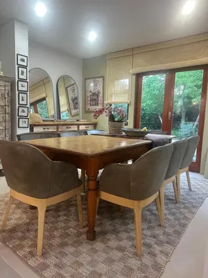 a dining room with a wooden table and chairs at Greyton Hideaway-on-Disa in Greyton