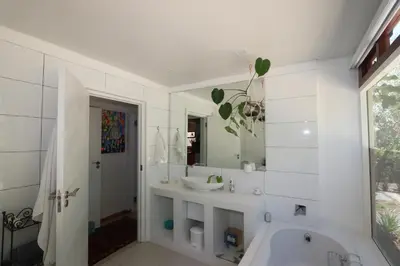 a bathroom with a tub and a sink and a mirror at Greyton Hideaway-on-Disa in Greyton