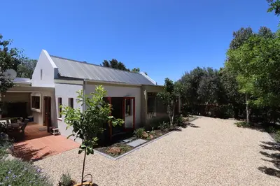a house with a gravel driveway in front of it at Greyton Hideaway-on-Disa in Greyton