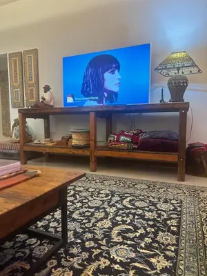 a living room with a large screen tv on a shelf at Greyton Hideaway-on-Disa in Greyton