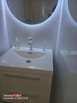 a bathroom with a white sink and a mirror at Classy Budget Apartment in Tyger Valley