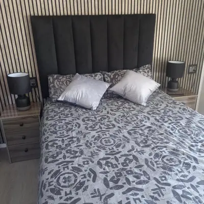 a bedroom with a large bed with two pillows at Forbes on Zastron in Cape Town