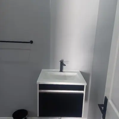 a bathroom with a white sink and a toilet at Forbes on Zastron in Cape Town