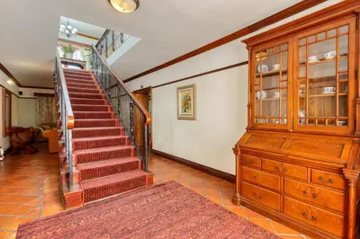 a staircase in a home with a wooden stair case at Berg en Zee Guesthouse in Gordonʼs Bay