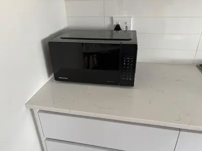a black microwave sitting on top of a counter at Casa Voliere in Stellenbosch