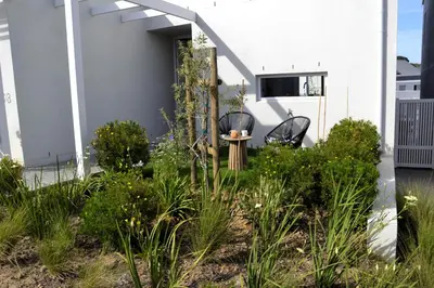 two chairs and a table in a garden at Casa Voliere in Stellenbosch
