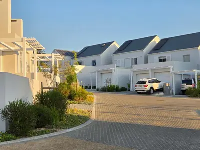 a car parked in front of a row of houses at Casa Voliere in Stellenbosch