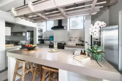 a large kitchen with a large white counter top at Exclusive Estate, Panoramic Beauty, Watersports in Lake Marina