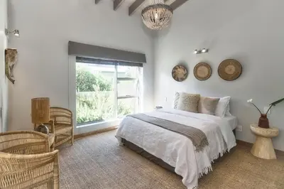 a white bedroom with a bed and a window at Exclusive Estate, Panoramic Beauty, Watersports in Lake Marina