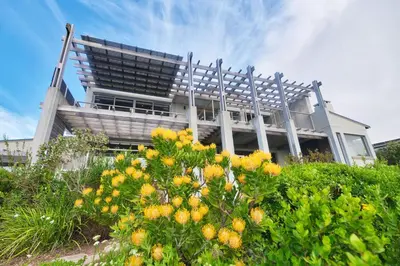 a building with a bunch of flowers in front of it at Exclusive Estate, Panoramic Beauty, Watersports in Lake Marina
