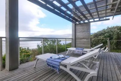 a deck with a picnic table and a bench at Exclusive Estate, Panoramic Beauty, Watersports in Lake Marina