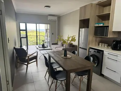 a kitchen and dining room with a table and chairs at Durbanville Daydream in Durbanville