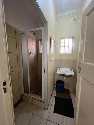 a bathroom with a shower and a sink at Heritage lodge in Cape Town