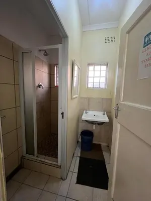 a bathroom with a shower and a sink at Heritage lodge in Cape Town