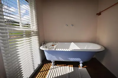 a bath tub in a bathroom with a window at Galileo Farm in Elgin